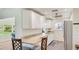 This bright, open kitchen has granite countertops, white cabinets, and stainless steel appliances at 4172 Oakhurst W Cir, Sarasota, FL 34233
