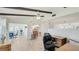 Open living space features wood-look tile flooring, beams, and natural light at 4172 Oakhurst W Cir, Sarasota, FL 34233