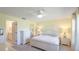 Light-filled main bedroom features a ceiling fan and ensuite bathroom at 4172 Oakhurst W Cir, Sarasota, FL 34233