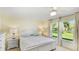 Bright main bedroom features two windows with views of the landscaped backyard at 4172 Oakhurst W Cir, Sarasota, FL 34233