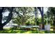 Oakhurst community entrance sign surrounded by lush landscaping and mature trees at 4172 Oakhurst W Cir, Sarasota, FL 34233