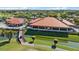 Aerial view of a clubhouse, golf cart path, and well-maintained landscaping within the community at 4210 Caddie E Dr # 201, Bradenton, FL 34203