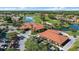 Aerial view showcasing a clubhouse, golf course, and lush landscaping within the community at 4210 Caddie E Dr # 201, Bradenton, FL 34203