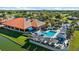 Aerial view showcasing a clubhouse with a pool, dining area, and well-maintained landscaping at 4210 Caddie E Dr # 201, Bradenton, FL 34203