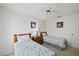 Comfortable bedroom featuring two twin beds with matching seashell themed bedspreads, coastal artwork, and a ceiling fan at 4210 Caddie E Dr # 201, Bradenton, FL 34203