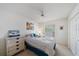 Comfortable bedroom featuring a double bed with floral themed pillows, bedside table with lamp and ceiling fan at 4210 Caddie E Dr # 201, Bradenton, FL 34203
