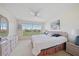 Bright bedroom with a large window, wicker furniture, and a comfortable bed, offering serene views at 4210 Caddie E Dr # 201, Bradenton, FL 34203
