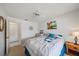 Comfortable bedroom featuring a double bed with floral themed pillows, bedside table with lamp and ceiling fan at 4210 Caddie E Dr # 201, Bradenton, FL 34203