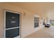Condo entrance with a view of a tiled walkway and seating area outside the doorway at 4210 Caddie E Dr # 201, Bradenton, FL 34203