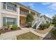 Inviting exterior view with manicured landscaping and white stairs leading to the second floor units at 4210 Caddie E Dr # 201, Bradenton, FL 34203
