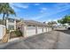 Detached garages with white doors and decorative side panels, enhancing curb appeal at 4210 Caddie E Dr # 201, Bradenton, FL 34203