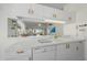 Close-up of a kitchen counter with white appliances and a view into the living room at 4210 Caddie E Dr # 201, Bradenton, FL 34203