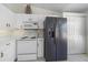Cozy kitchen with white cabinets, appliances, and updated refrigerator, offering plenty of storage space at 4210 Caddie E Dr # 201, Bradenton, FL 34203