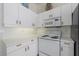 Bright kitchen features white cabinetry and appliances with wooden hardware and a decorative shelf at 4210 Caddie E Dr # 201, Bradenton, FL 34203