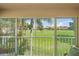 View from enclosed lanai showing well-maintained green space and neighboring homes at 4210 Caddie E Dr # 201, Bradenton, FL 34203