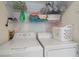 Clean laundry area featuring a white washer and dryer, with shelves stocked with supplies above at 4210 Caddie E Dr # 201, Bradenton, FL 34203