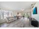 Bright living room with vaulted ceilings, tile floors, and sliding glass doors to the patio at 4210 Caddie E Dr # 201, Bradenton, FL 34203