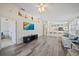 Open concept floorplan offering hardwood floors and a large flat screen TV on the wall at 4210 Caddie E Dr # 201, Bradenton, FL 34203