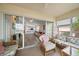 Inviting screened-in lanai with comfortable seating and views of the indoor living space with sliding doors at 4210 Caddie E Dr # 201, Bradenton, FL 34203