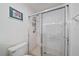 A tiled shower with glass doors and a chrome shower head and mounted caddy at 4210 Caddie E Dr # 201, Bradenton, FL 34203