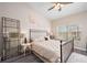 Bright bedroom features a ceiling fan, dark wood floors, and ample natural light at 4264 Central Sarasota Pkwy # 125, Sarasota, FL 34238