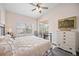 Bright bedroom features a ceiling fan, a view of the balcony, and natural light at 4264 Central Sarasota Pkwy # 125, Sarasota, FL 34238