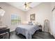 Comfortable bedroom featuring a dark wood floor, a window, and an accent mirror at 4264 Central Sarasota Pkwy # 125, Sarasota, FL 34238