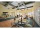 Large open clubhouse interior with seating areas, tables, and festive decorations at 4264 Central Sarasota Pkwy # 125, Sarasota, FL 34238