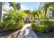 Beautiful condo building entrance with lush tropical landscaping and charming walkway at 4264 Central Sarasota Pkwy # 125, Sarasota, FL 34238