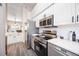 Modern kitchen with stainless steel appliances, and white cabinets provides convenience and style at 4264 Central Sarasota Pkwy # 125, Sarasota, FL 34238