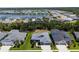 Aerial view of a residential community with a lake, lush greenery, and well-maintained homes at 4308 Fly Rod Ter, Parrish, FL 34219