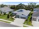 Aerial view of a home shows a lush landscape, a three-car garage, and a well-manicured lawn at 4308 Fly Rod Ter, Parrish, FL 34219
