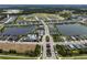 Aerial view of a Primary-planned community showcases the layout, lakes, community pool, and surrounding landscape at 4308 Fly Rod Ter, Parrish, FL 34219