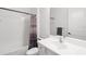 Bright bathroom with a white vanity, toilet, shower-tub combo, and neutral patterned shower curtain at 4308 Fly Rod Ter, Parrish, FL 34219