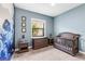 Beautiful bedroom with a dinosaur wall design, crib, and wooden dresser at 4308 Fly Rod Ter, Parrish, FL 34219