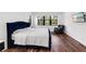 Serene bedroom features a tufted bed, chair, large window, and hardwood floors at 4308 Fly Rod Ter, Parrish, FL 34219