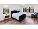 Comfortable bedroom features a tufted bed, hardwood floors and bright natural light at 4308 Fly Rod Ter, Parrish, FL 34219