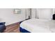 Comfortable bedroom features a tufted bed, hardwood floors, and a tv at 4308 Fly Rod Ter, Parrish, FL 34219