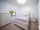 Well-lit bedroom featuring a full bed, side tables, and chest of drawers at 4308 Fly Rod Ter, Parrish, FL 34219
