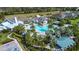 Aerial view of the community pool surrounded by palm trees, lounge chairs, and lush landscaping at 4308 Fly Rod Ter, Parrish, FL 34219