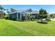 Landscaped home featuring well manicured grass and beautiful blue and white color scheme at 4308 Fly Rod Ter, Parrish, FL 34219