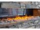 A close-up highlighting the texture of a stacked stone fireplace with a gas insert at 4308 Fly Rod Ter, Parrish, FL 34219