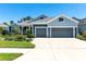 Charming home showcasing a light blue exterior, with a two-car garage and manicured landscaping at 4308 Fly Rod Ter, Parrish, FL 34219
