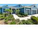 Inviting home exterior with a covered porch, lush landscaping, and a well-maintained walkway at 4308 Fly Rod Ter, Parrish, FL 34219