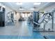 Modern gym with weight machines, treadmills, mirrored walls, and ceiling fans provides a great workout space at 4308 Fly Rod Ter, Parrish, FL 34219