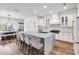 Kitchen featuring a large island, sleek white cabinetry, and an adjacent dining area at 4308 Fly Rod Ter, Parrish, FL 34219
