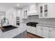 Modern kitchen features white cabinets, stainless steel appliances, and a large island with marble countertop at 4308 Fly Rod Ter, Parrish, FL 34219