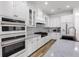 A bright, updated kitchen with white cabinets, tile backsplash, and state-of-the-art appliances at 4308 Fly Rod Ter, Parrish, FL 34219