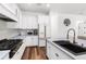 Modern kitchen features custom white cabinetry, stainless steel appliances, and stylish finishes at 4308 Fly Rod Ter, Parrish, FL 34219