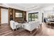 Open-concept living room with a stone fireplace, stylish decor, and a view of the dining area at 4308 Fly Rod Ter, Parrish, FL 34219